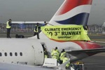 Activistas del grupo ecologista Greenpeace se suben a la cola de un avión en el aeropuerto de Heathrow para protestar contra la construcción de una tercera pista de aterrizaje.