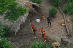Miembros de la nueva tribu descubierta en Brasil apuntan al aire con sus arcos desde donde se les está fotografiando.